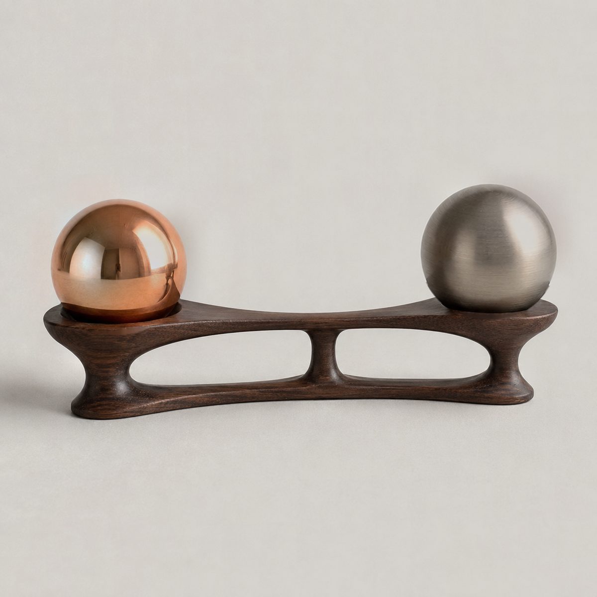 Yoke, ARKA II: copper, steel spheres resting in seats carved into a walnut form